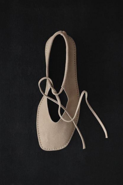Beige suede ballerina shoes.