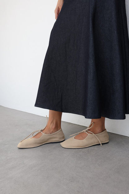 Beige suede ballerina shoes.