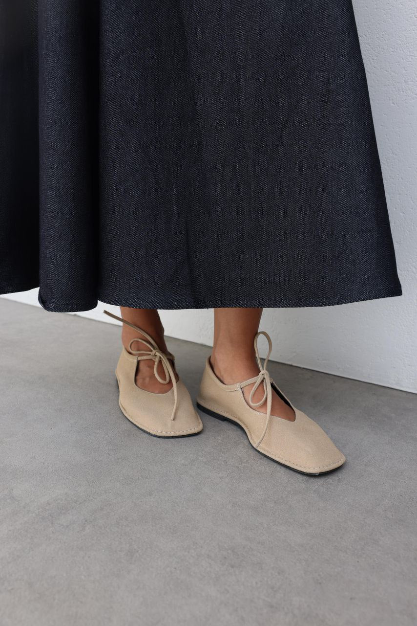 Beige suede ballerina shoes.